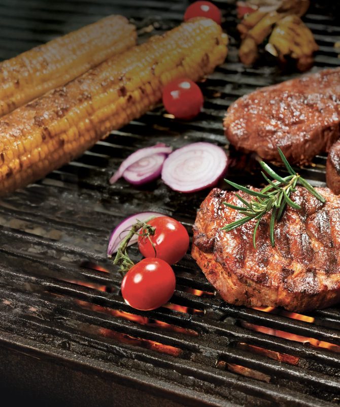 Assorted delicious grilled meat with vegetable over the coals on a barbecue